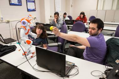 QCC students work with computer software to control robot