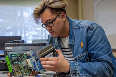 Student looking inside computer