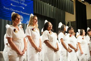QCC nursing graduates stand for nursing pinning