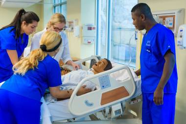 QCC students practice healthcare techniques on dummy