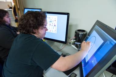 QCC student illustrates with computer screen tablet