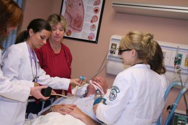 QCC students and instructor work on patient