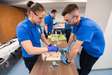 Paramedic students practice in the lab