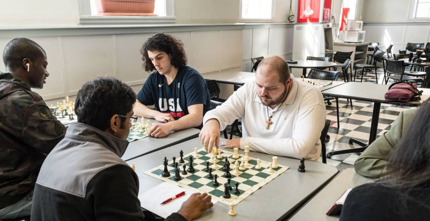Students play chess in the cafeteria